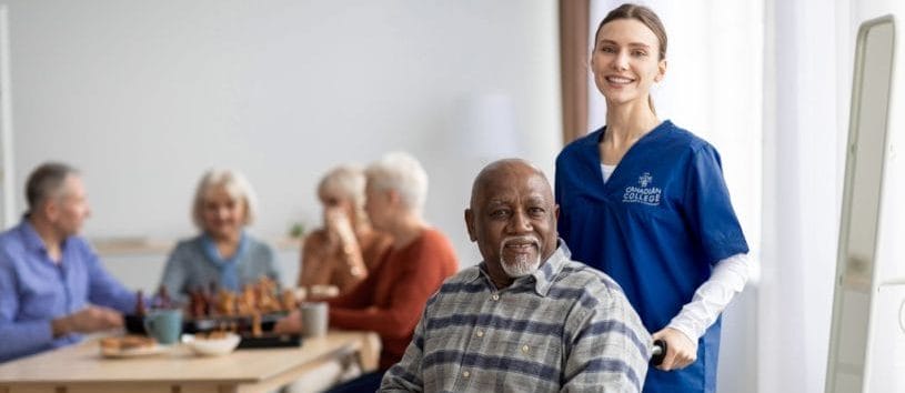 Personal Support Worker supporting a man in a wheelchair.